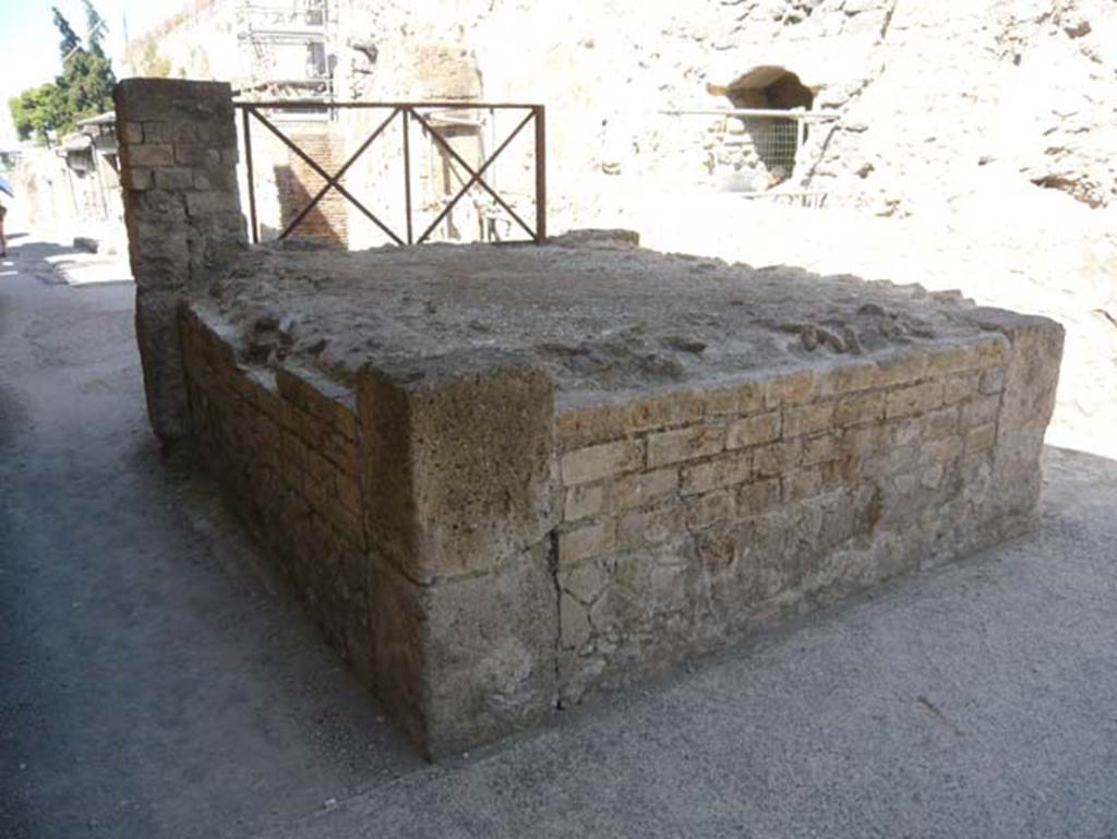 VI 24, Herculaneum. August 2013. Looking south from rear of steps. Photo courtesy of Buzz Ferebee.
According to Wallace-Hadrill, “No wagons or carts carrying supplies to shops and private houses could pass here. Even Cardo III was end-stopped. A rectangular structure, a little over a metre high, stands in the way of traffic. Its function is not obvious. It has been identified as a tribunal, or suggestum, from which a magistrate could address the people or a public crier could make an announcement. An alternative would be to see it as a base of a small shrine.”
See Wallace-Hadrill, A. (2011). Herculaneum, Past and Future. London, Frances Lincoln Ltd., (p.177).